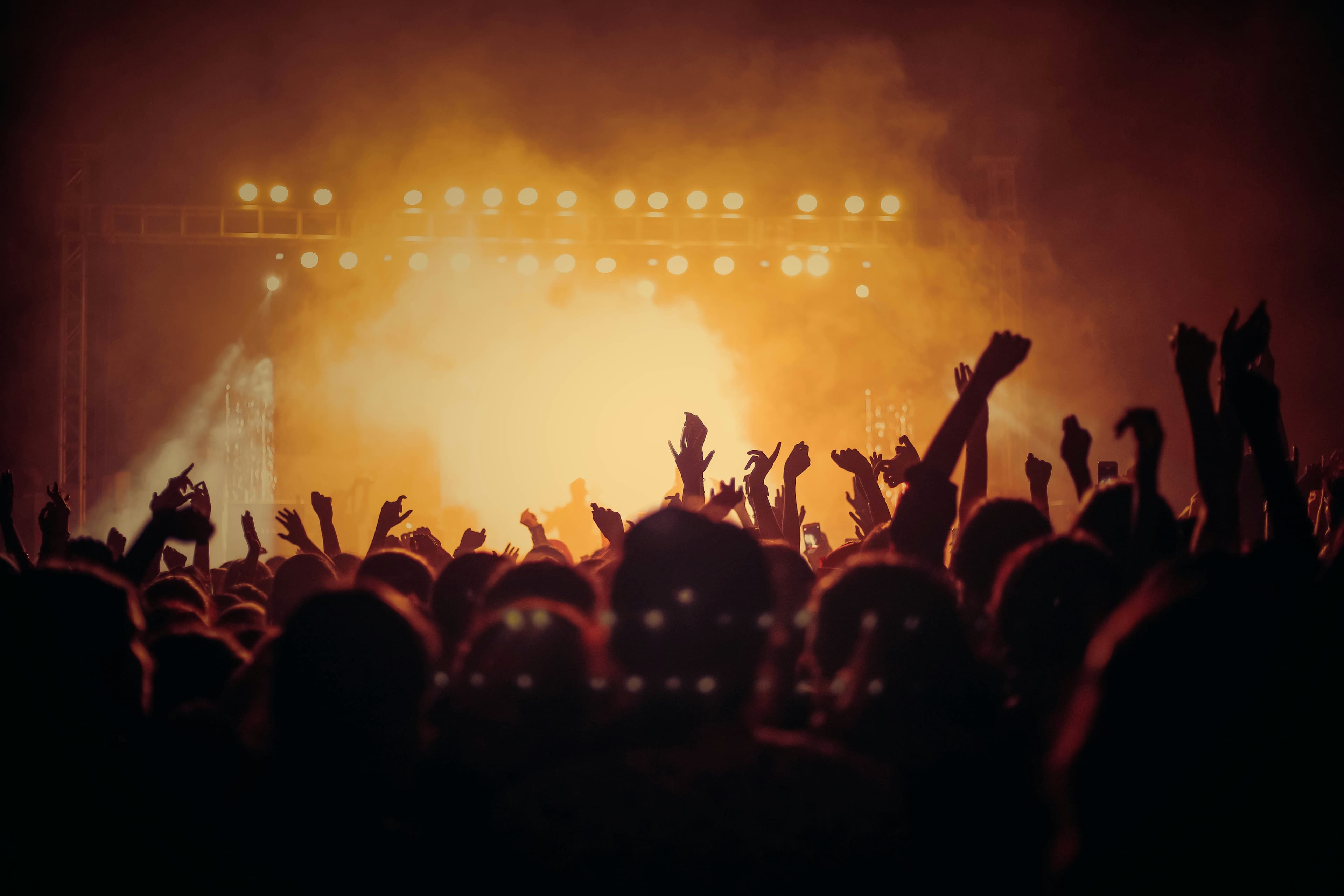 crowd raving in yellow light